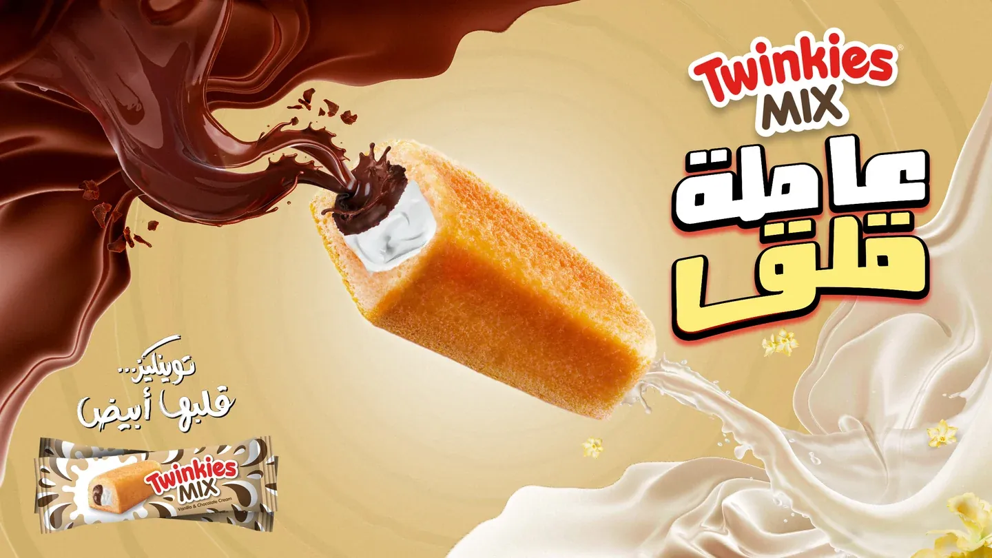 Twinkies Mix artwork with a cream-filled cake between flowing chocolate and cream