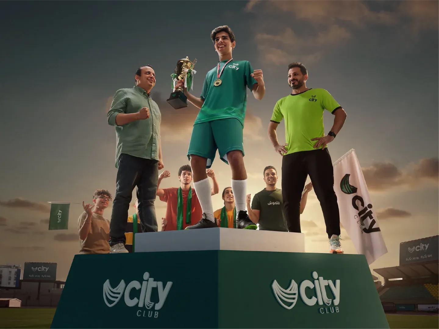 CityClub outdoor football podium artwork with a young player holding a trophy