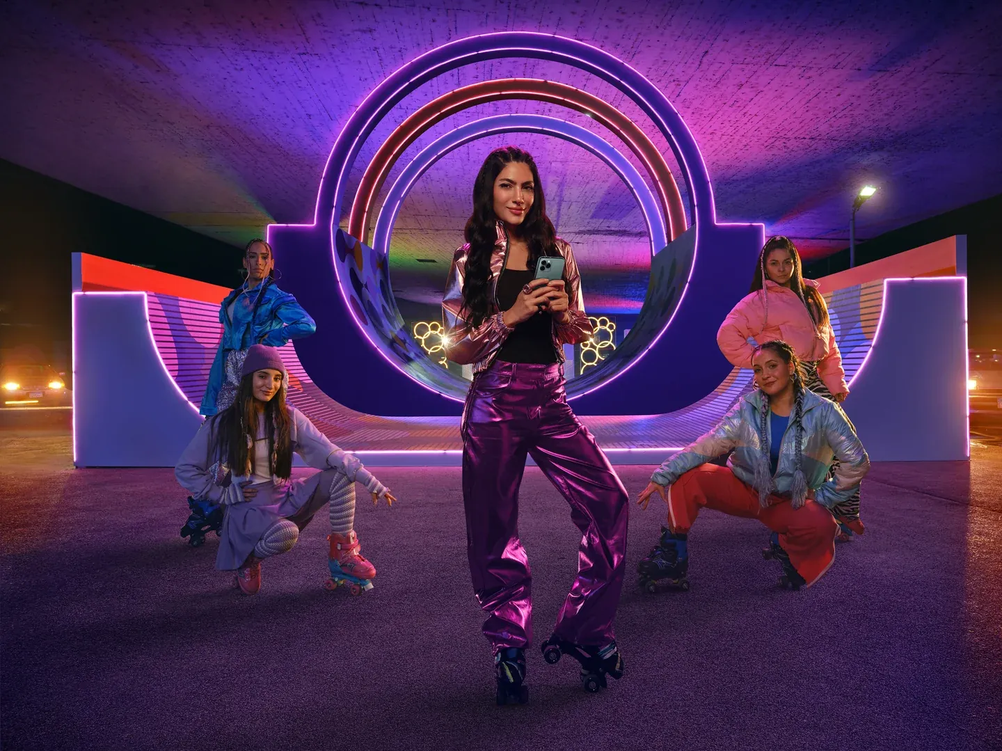 WE campaign scene with a woman playing saxophone among dancers on a purple-lit stage
