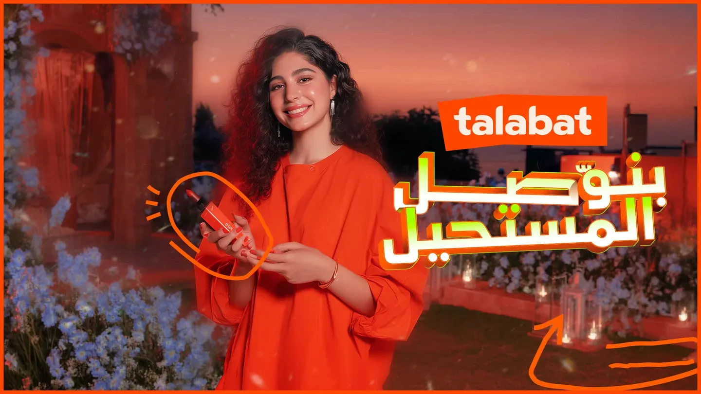 Talabat artwork with a woman in orange holding shopping bags among flowers