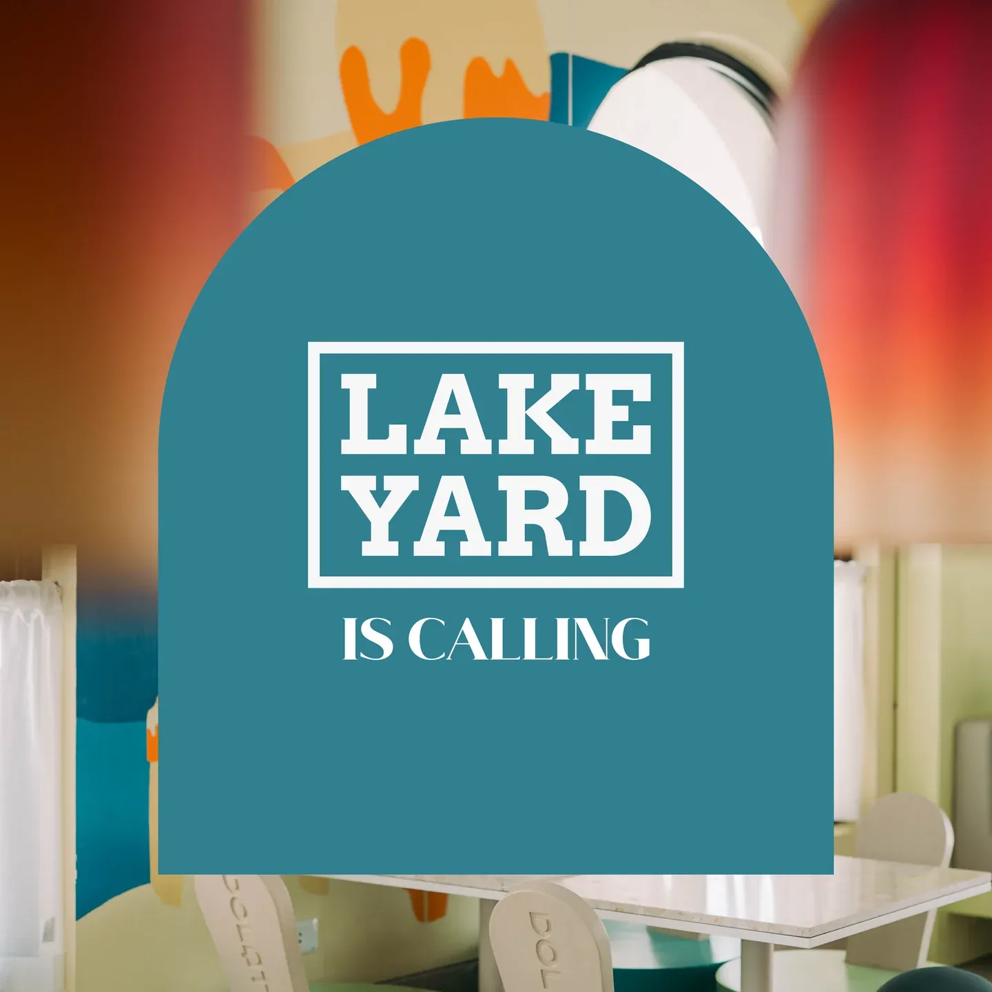 Lakeyard Is Calling artwork with a teal arch over a softly blurred café scene